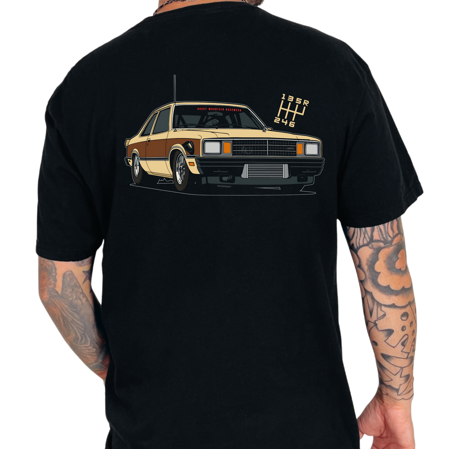 Black t-shirt with a Fairmont car graphic on the back, worn by a person with tattoos.