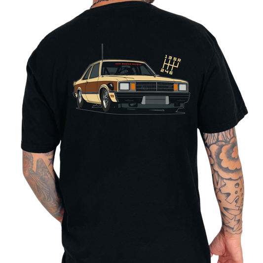 Black t-shirt with a Fairmont car graphic on the back, worn by a person with tattoos.
