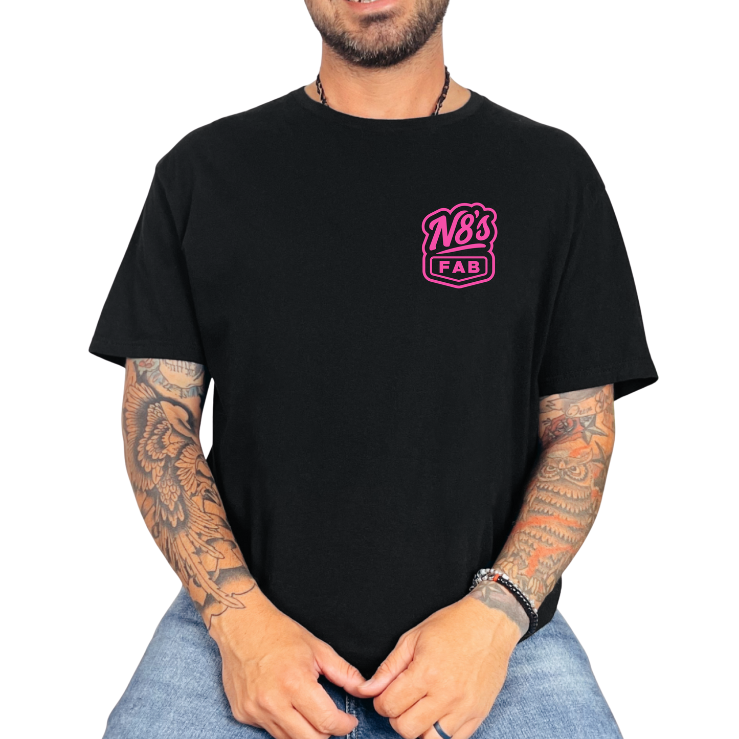 Person wearing a black t-shirt with a pink logo on a white background